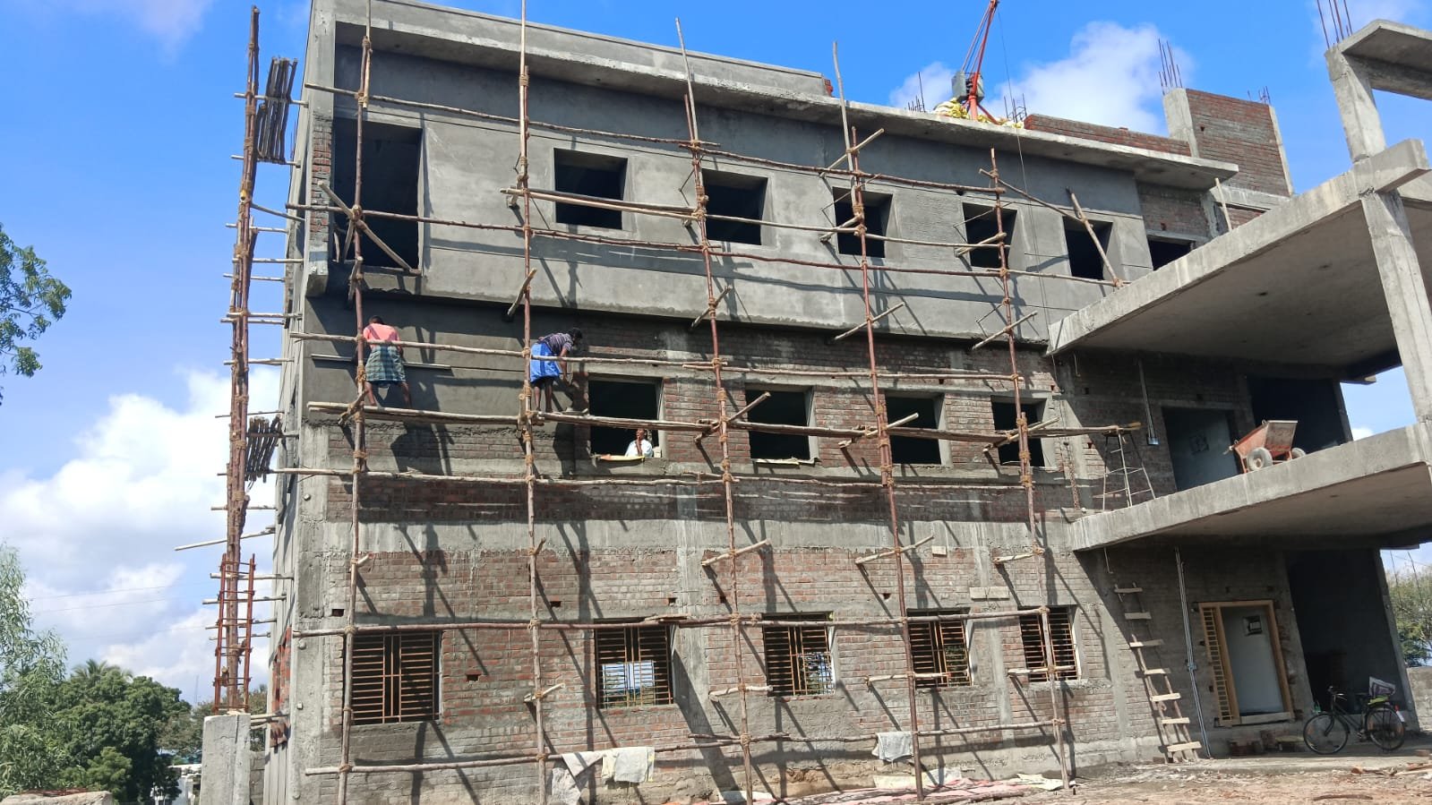 Multi-storey commercial building under construction with brickwork