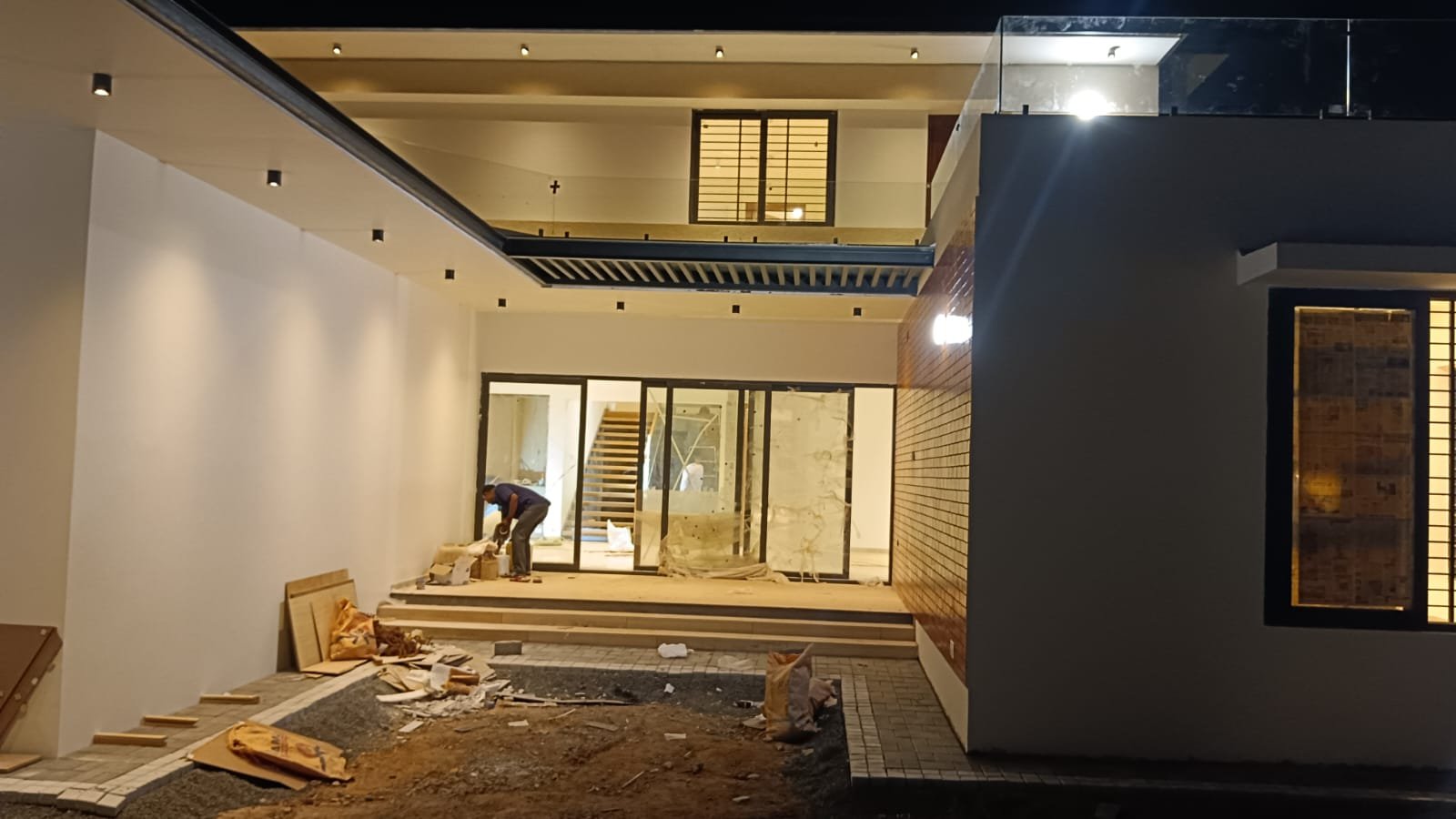 Villa interior courtyard at night during finishing work in Karur