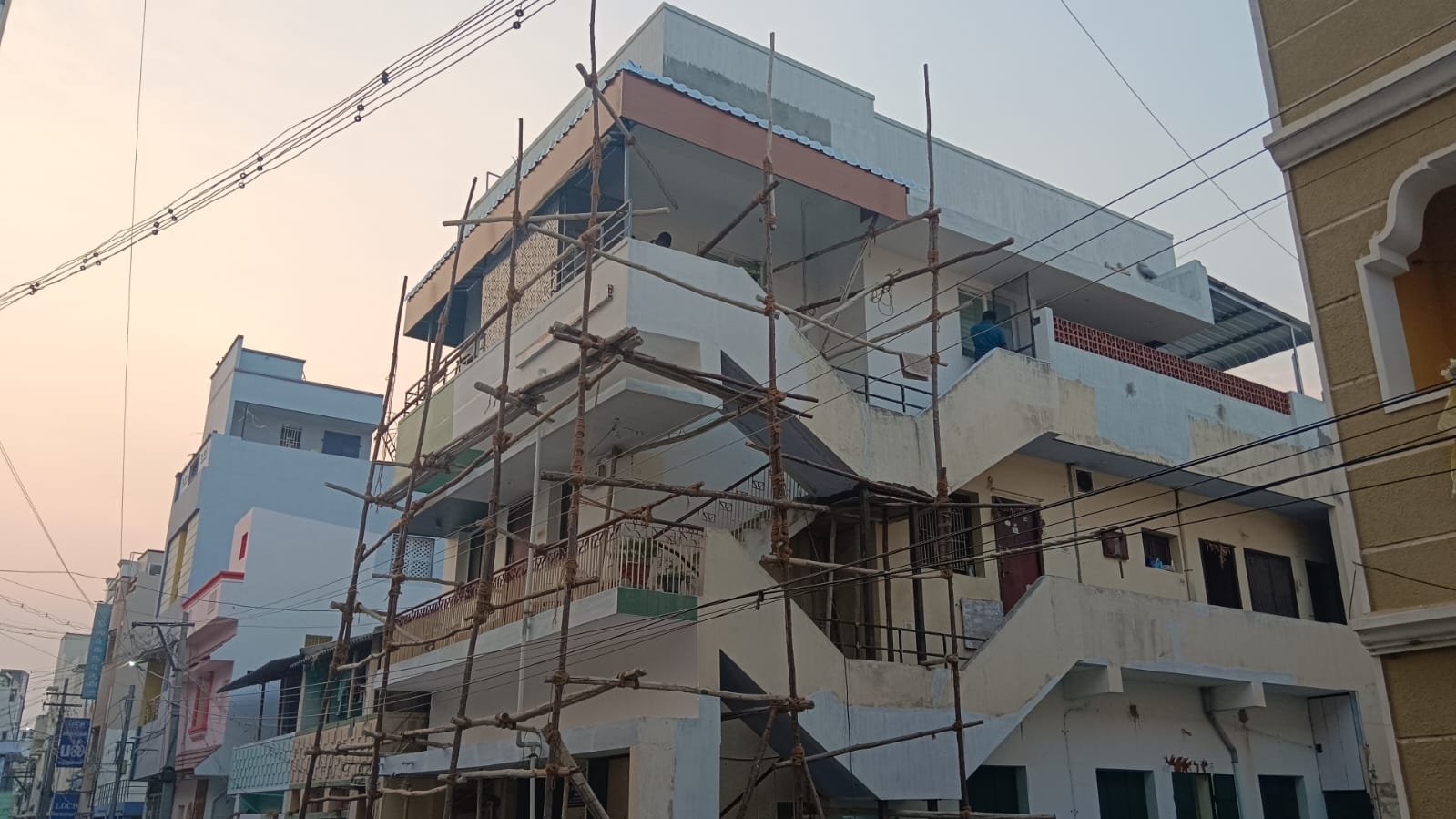 Multi-storey building under construction photographed in the evening